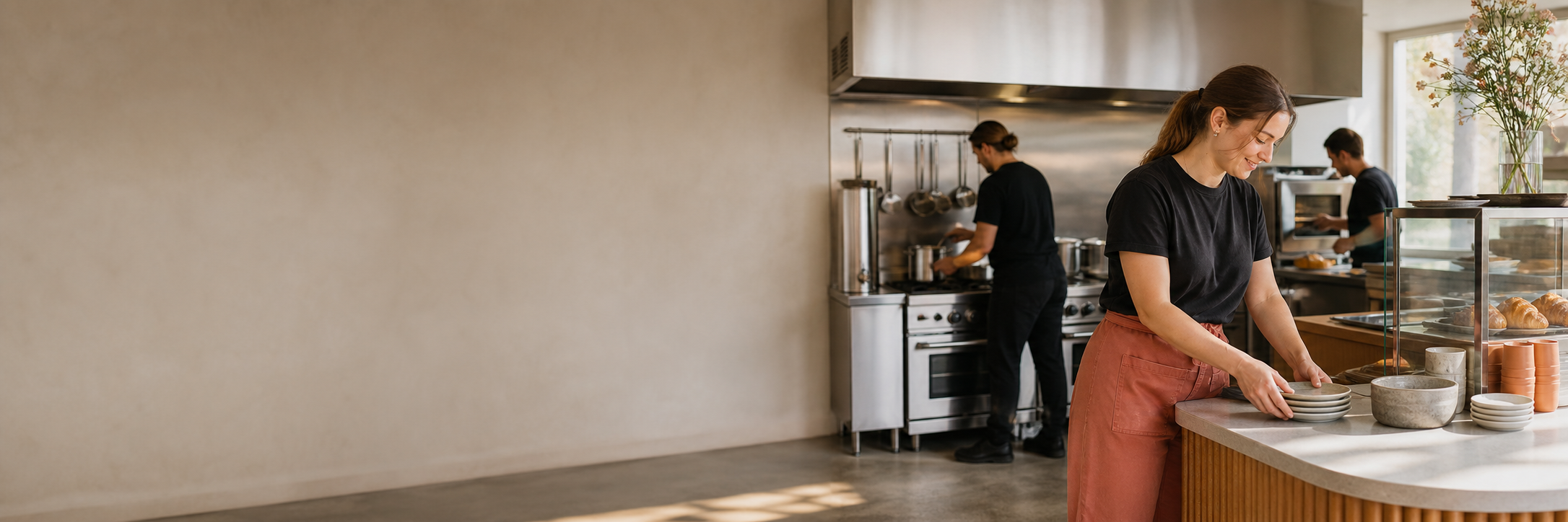 Hospitality staff preparing a commercial kitchen for service